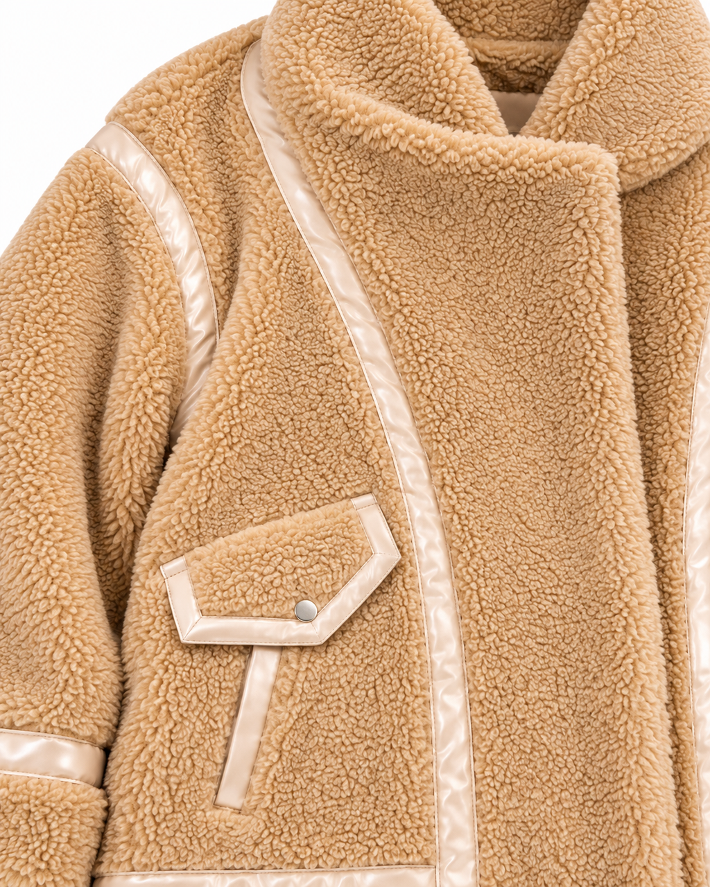 Close-up of the jacket’s plush tan sherpa texture and contrast lace-style trim along a pocket
