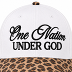 Close-up of One Nation Under God Baseball Cap in Leopard showing bold black embroidered script reading One Nation in cursive and Under God in block lettering on white structured cotton crown with tan and black leopard print bill at bottom edge and leopard print top button
