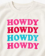 Close-up of four colorful HOWDY graphics and the ribbed crew neckline on the cream sweatshirt
