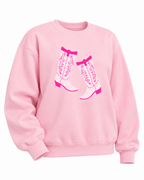Angled front view of the pink cowboy boots sweatshirt showing long sleeves and ribbed cuffs and hem
