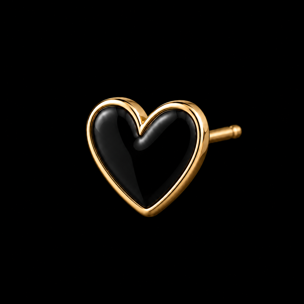 Close-up of single black enamel heart stud earring with polished gold-tone bezel setting and gold post backing on black background
