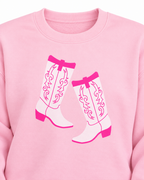 Close-up of the white cowboy boot graphic with hot pink detailing and the ribbed neckline on the pink sweatshirt
