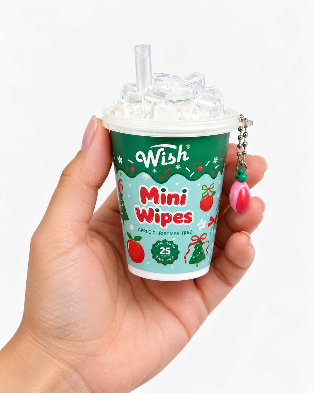 Apple Christmas Tree mini wipes cup held in one hand to show its compact size, decorative clear lid, and dangling apple charm
