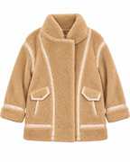 Front view of the tan sherpa jacket showing its full zipper, high collar, and contrast trim
