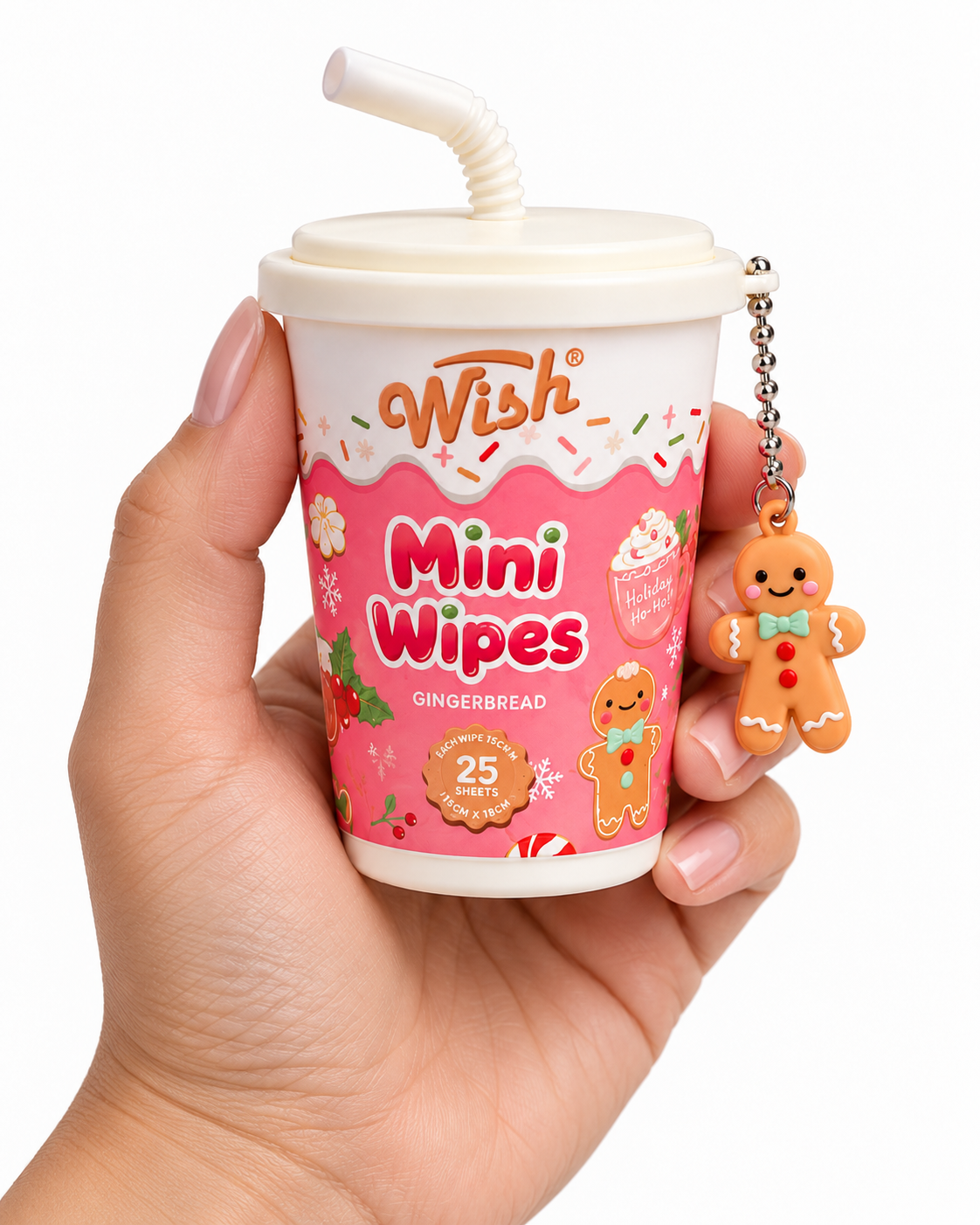 Gingerbread mini wipes cup held in one hand to show its compact size, pink holiday packaging, white lid, and dangling gingerbread charm

