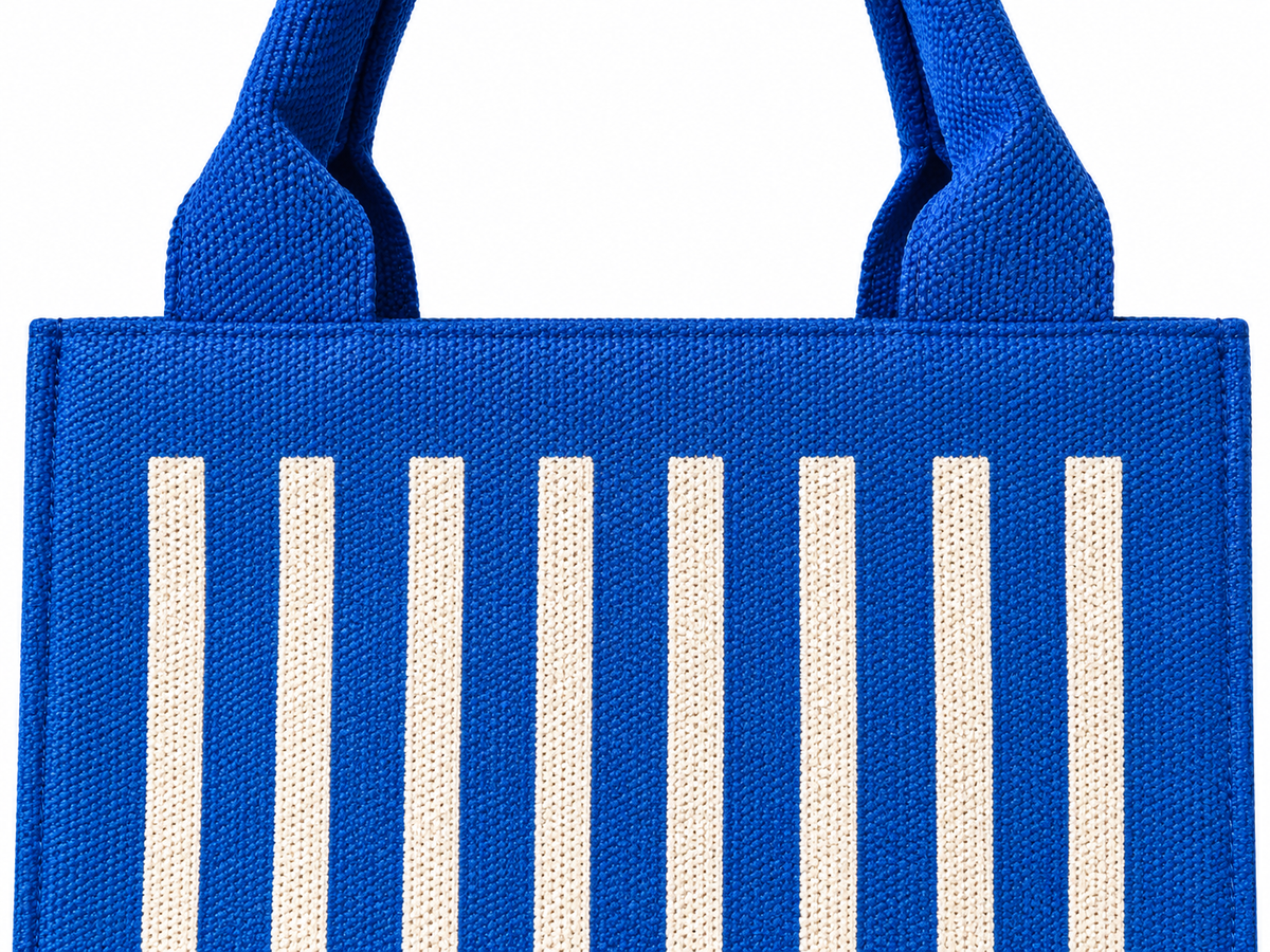Close-up of Mini Blue Striped Tote Handbag showing vivid cobalt blue woven texture with natural cream vertical stripe ribbed detail and matching blue rounded top handles
