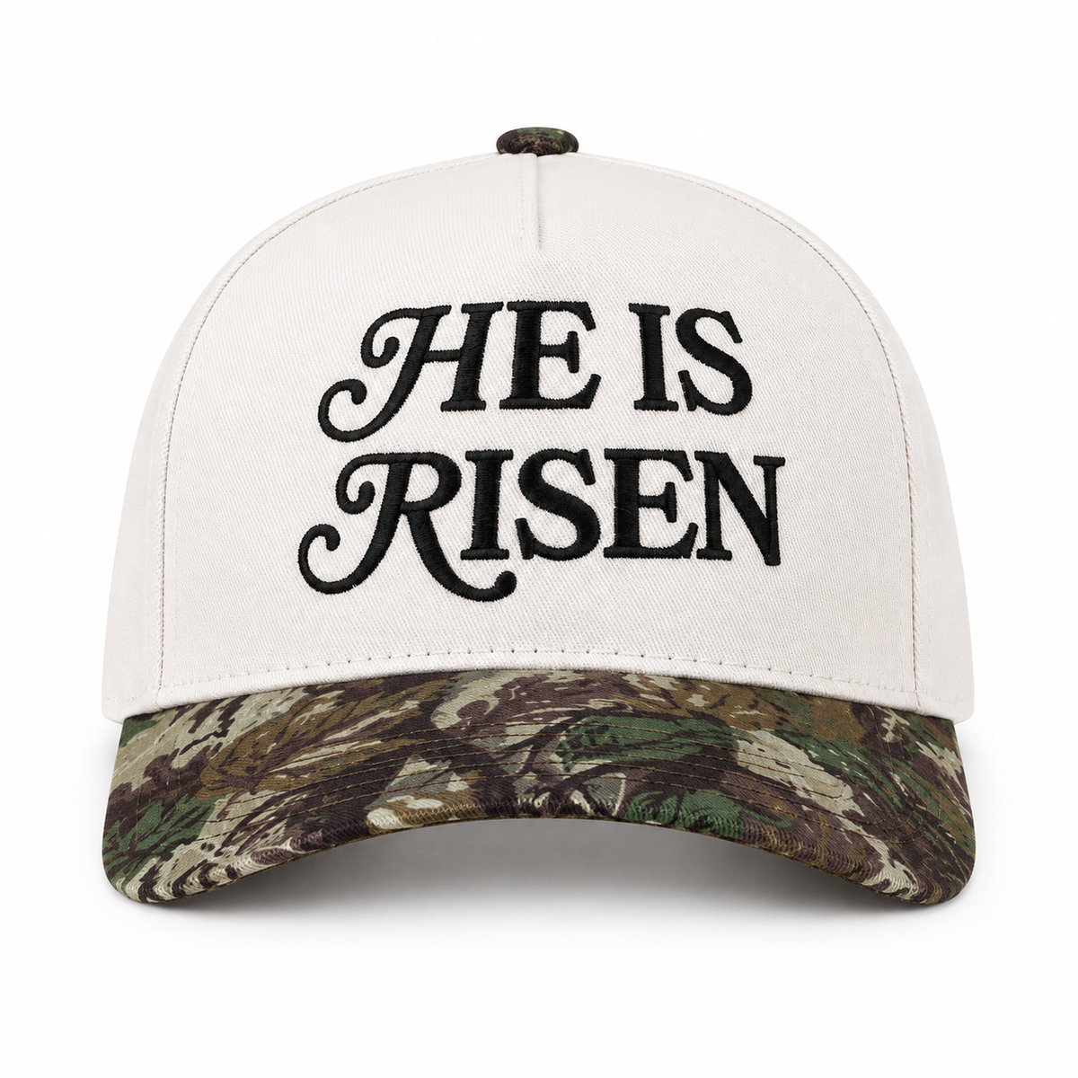 He Is Risen Baseball Cap in Camo front view showing white cotton crown with black decorative script He Is Risen embroidery, green and brown mossy oak camouflage bill, and camo top button on white background
