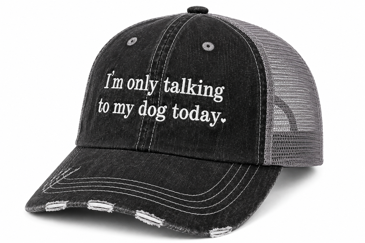 I'm Only Talking to My Dog Today trucker hat in washed black with gray mesh back and embroidered script, shown on a gray background.
