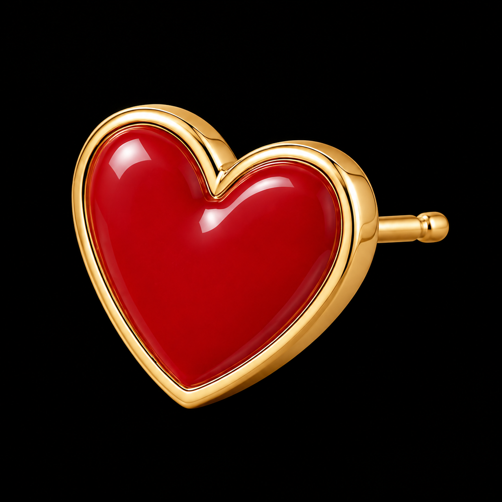 Close-up of single red enamel heart stud earring with polished gold-tone bezel setting and post backing on black background
