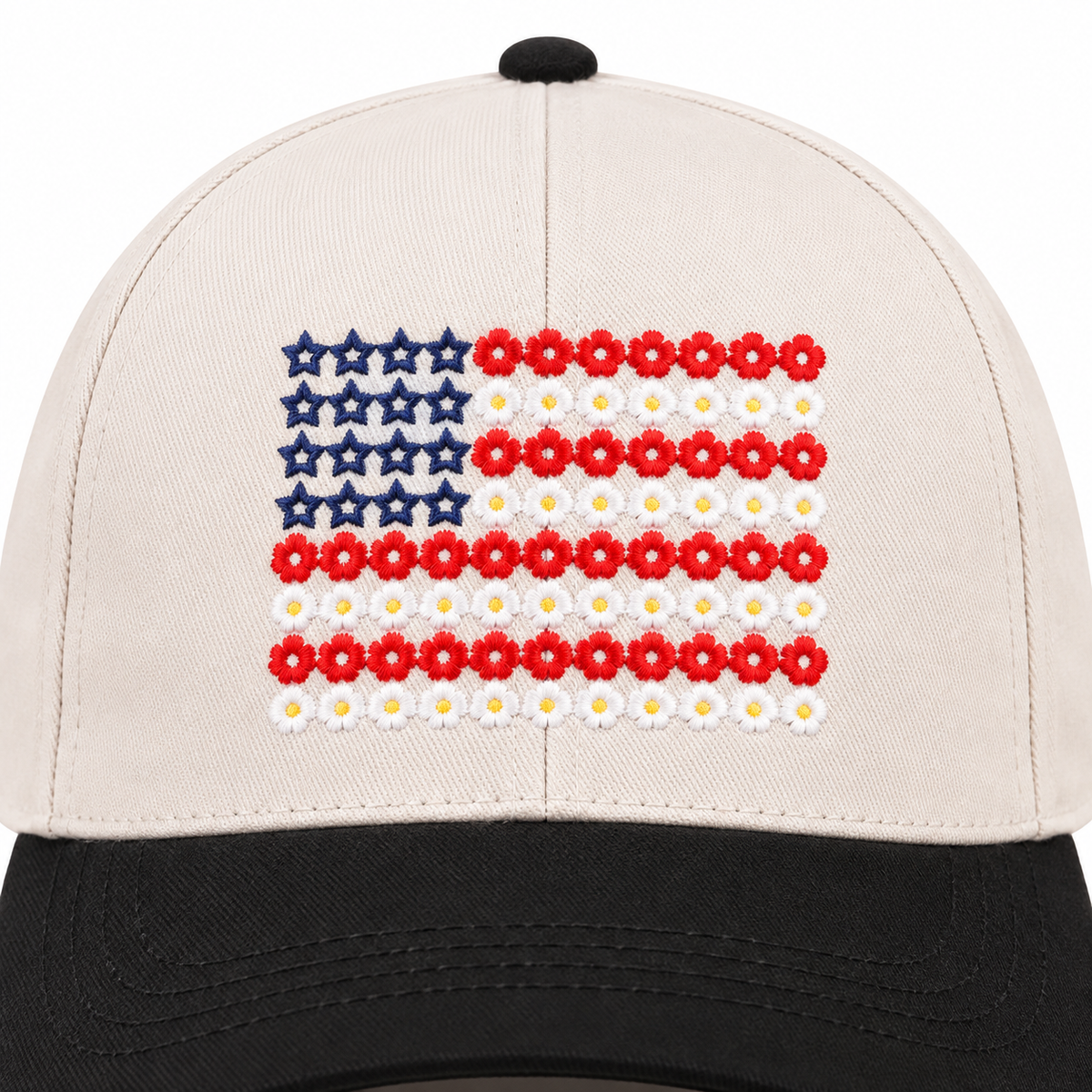 Close-up of Star Floral American Flag Baseball Cap in Black showing detailed floral American flag embroidery with navy blue star outlines in upper left canton, alternating rows of red daisy flowers and white daisy flowers forming stripes on cream structured cotton crown with black bill edge at bottom
