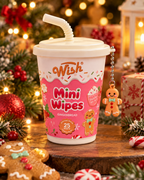 Gingerbread mini wipes in a pink cup displayed with wrapped Christmas gifts, gingerbread cookies, ornaments, and warm holiday lights
