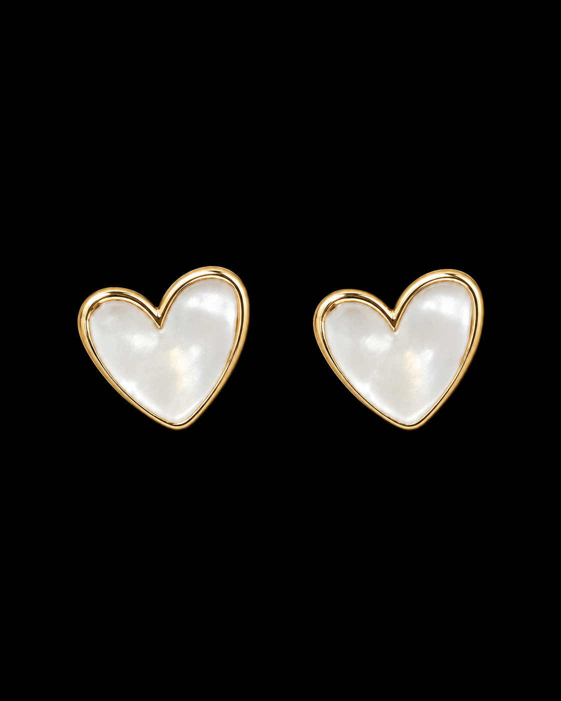 Pearl heart stud earrings with polished gold-tone bezel trim shown as a pair front-facing on black background
