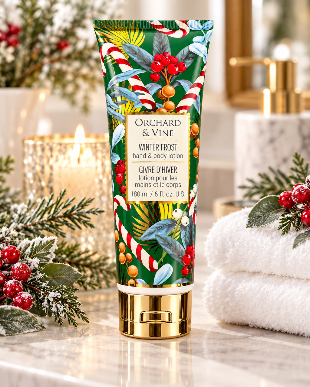 Winter Frost hand and body lotion in a green holiday tube with a gold-tone cap, displayed beside towels, candles, and winter greenery
