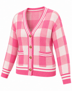Pink Plaid Gold Button Knit Cardigan three-quarter angle view showing pink and white plaid pattern, V-neck with striped trim, gold dome buttons, front patch pockets, and striped ribbed hem and cuffs on white background
