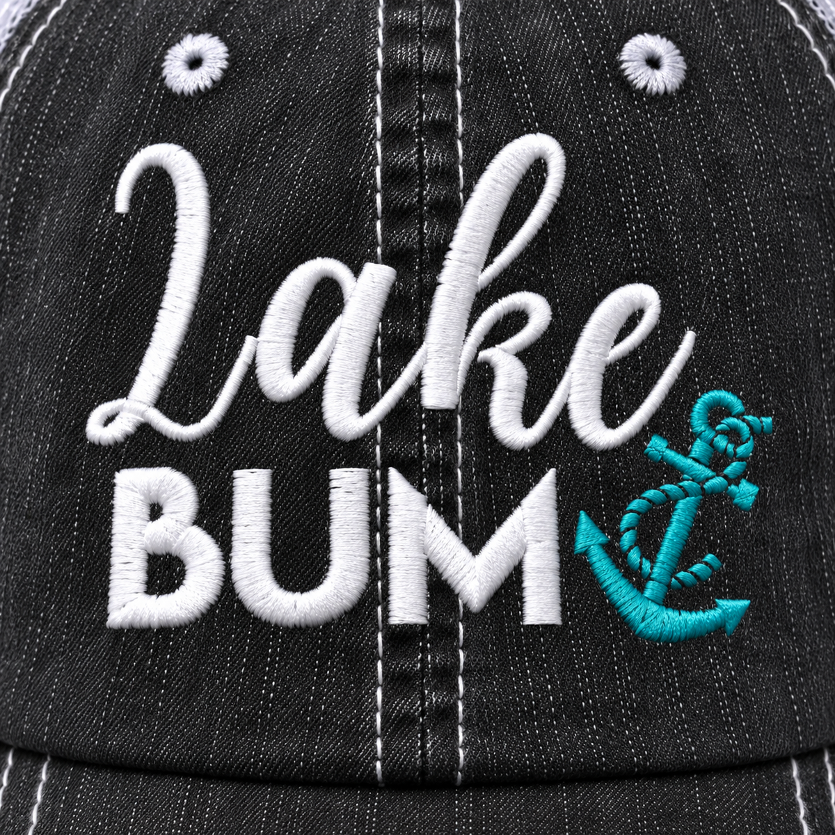 Close-up of a black baseball cap with white embroidered text reading 'Lake BUM' and a turquoise anchor graphic on the front.