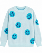 Front view of the light blue knit sweater with turquoise happy faces, dark blue eyes and smiles, and ribbed neckline, cuffs, and hem
