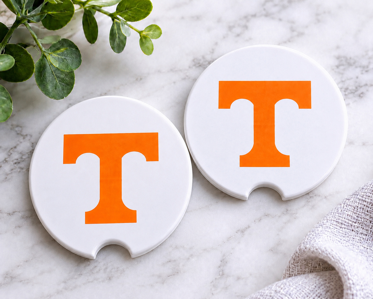 Tennessee Power T Car Coaster Set — set of 2 white ceramic coasters with bold orange Tennessee Power T logo, on marble surface
