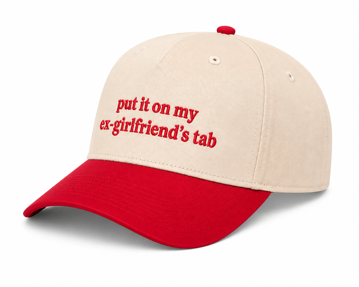 Side view of Put It On My Ex-Girlfriend's Tab Baseball Cap showing cream structured crown, red brim, and solid back, on a white background.
