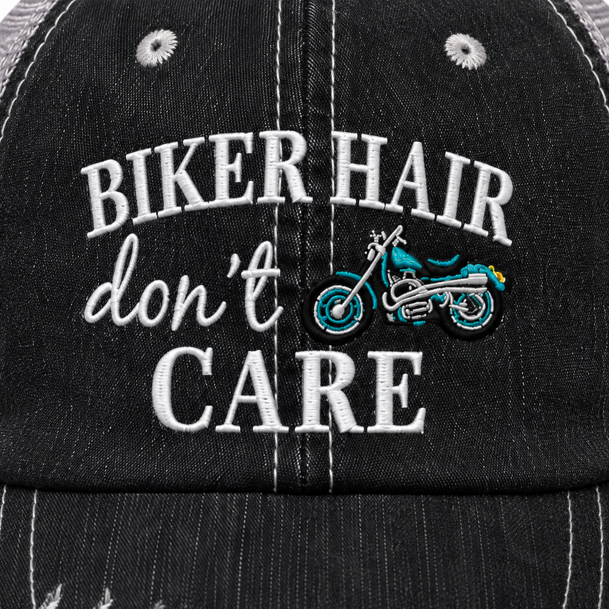 Close-up of Biker Hair Don’t Care trucker hat showing white embroidered lettering and colorful motorcycle design