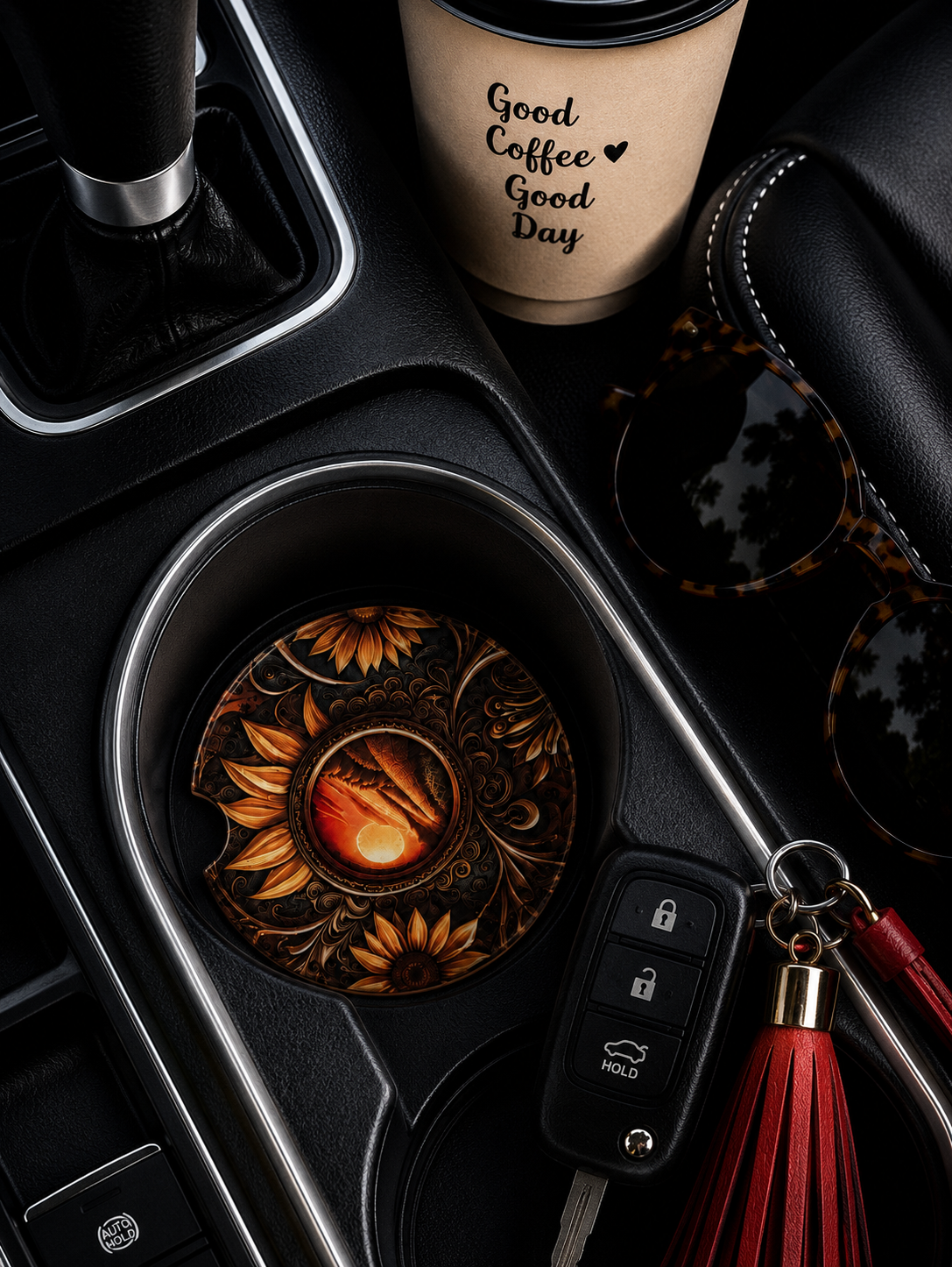 Sunflower Tooled Leather ceramic car coaster in cup holder — dark amber tooled leather sunflowers and glowing sunset medallion design, shown in car console with coffee cup and sunglasses
