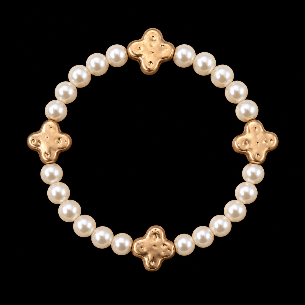 Pearl bead stretch bracelet with four evenly spaced hammered gold-tone clover accents displayed flat in a circle on black background

