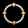 Pearl bead stretch bracelet with four evenly spaced hammered gold-tone clover accents displayed flat in a circle on black background
