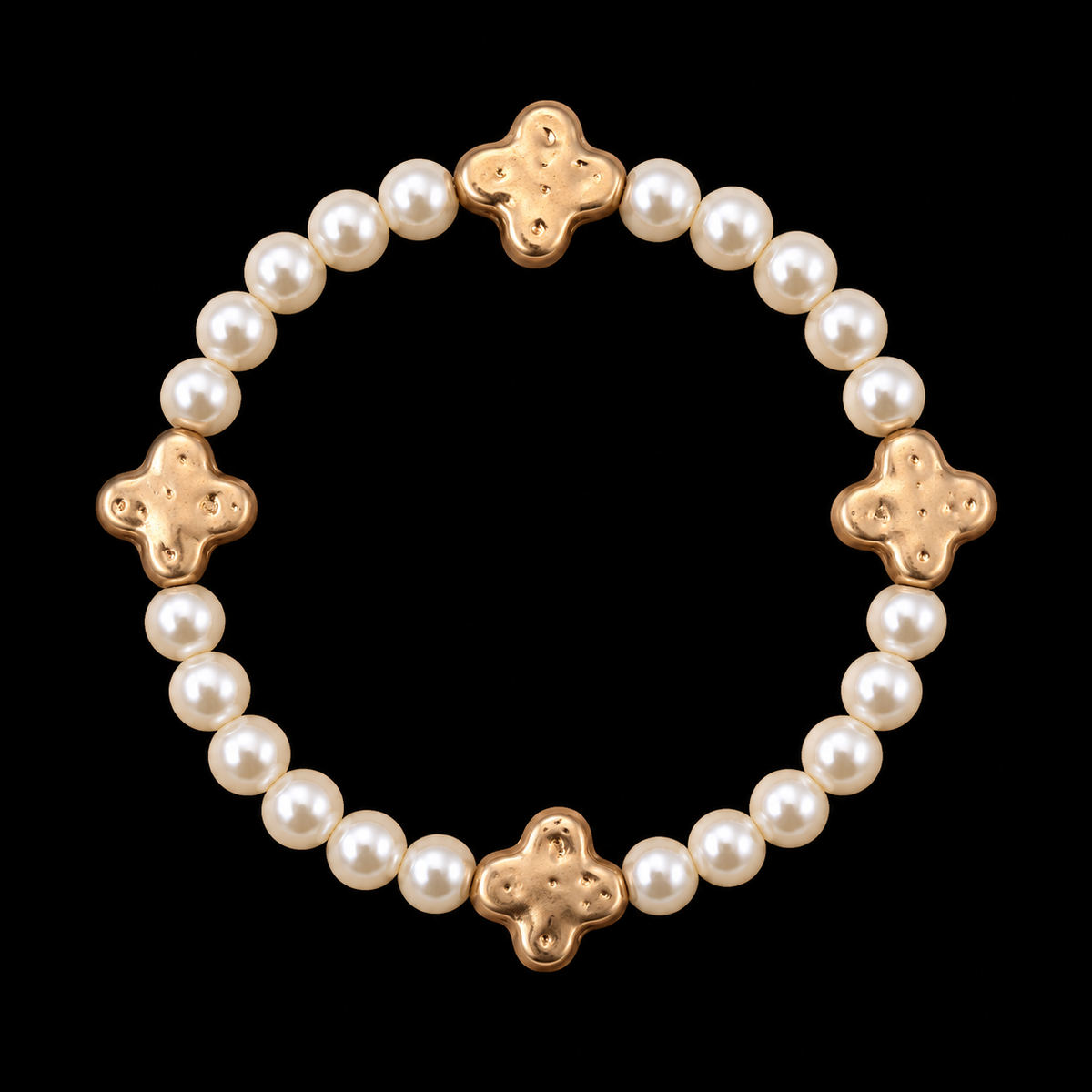 Pearl bead stretch bracelet with four evenly spaced hammered gold-tone clover accents displayed flat in a circle on black background
