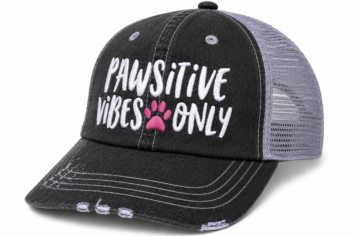 Side view of Pawsitive Vibes Only trucker hat in distressed black with gray mesh back and embroidered lettering, shown on a white background.

