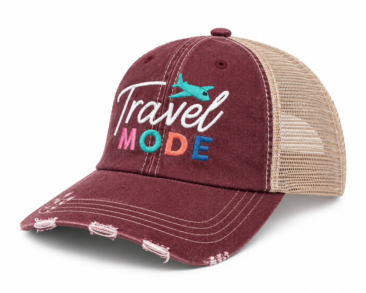 Side view of Travel Mode trucker hat with burgundy distressed front, colorful embroidery and tan mesh back