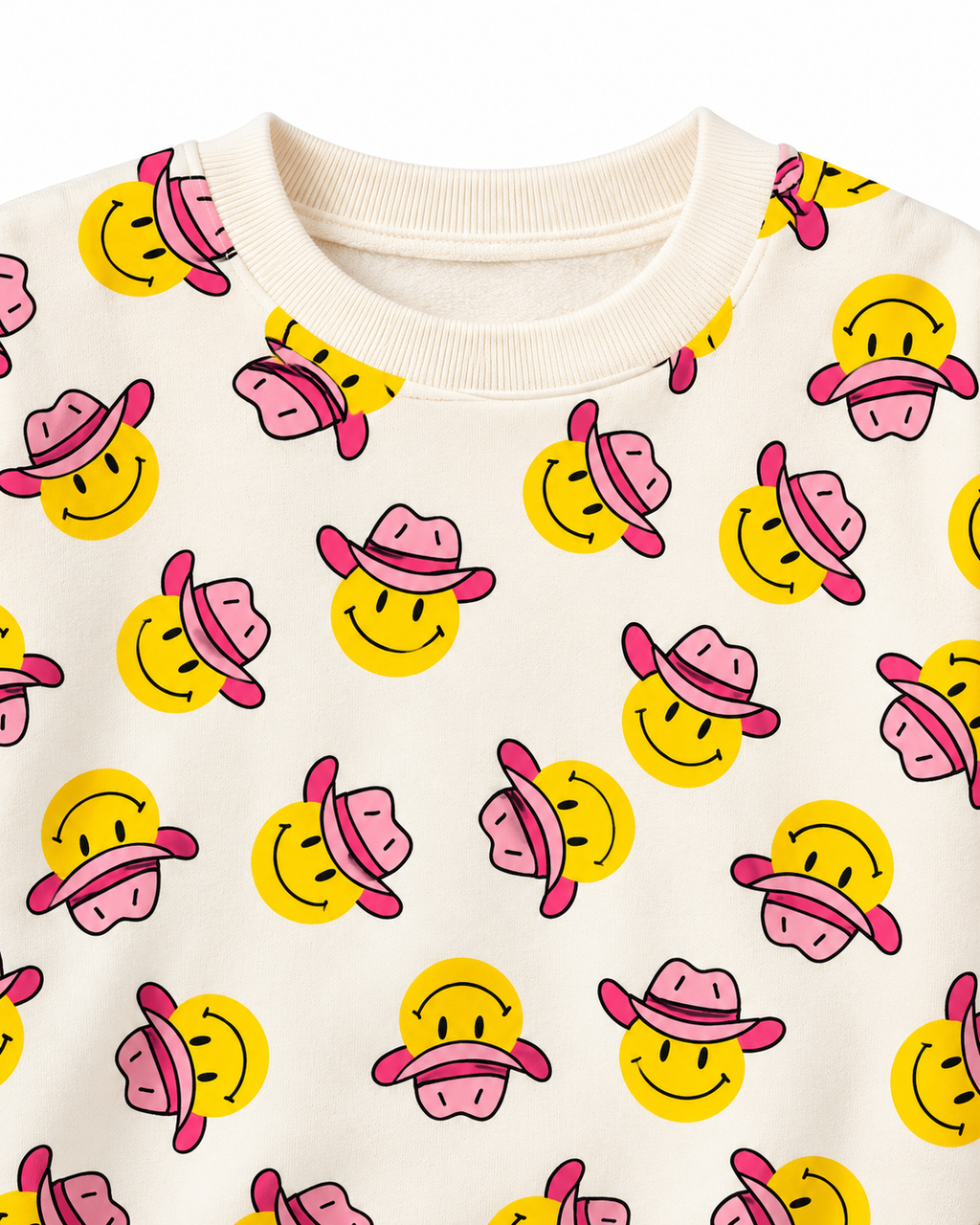 Close-up of yellow smiley faces wearing pink cowgirl hats beside the cream ribbed crew neckline

