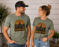 Man and woman modeling front and back views of Bigfoot Research Team graphic tee