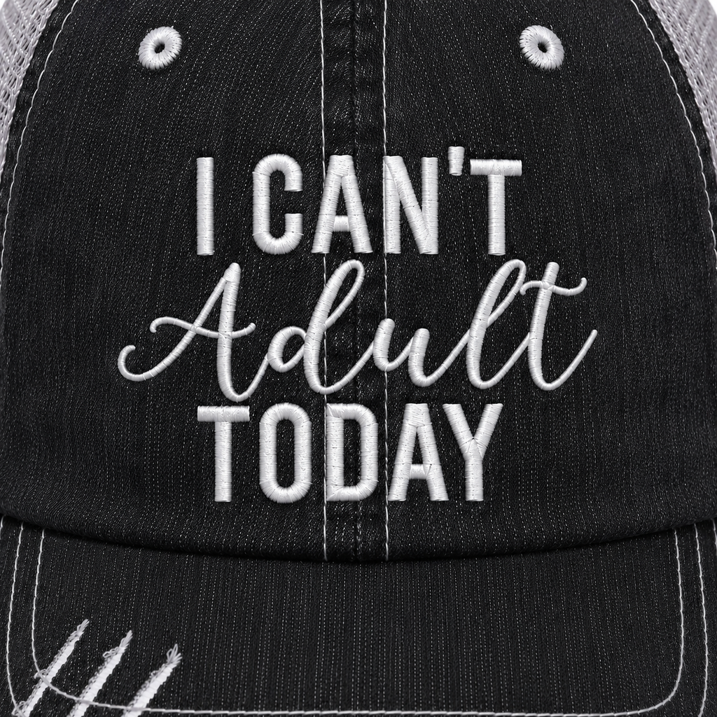 Close-up of I Can't Adult Today trucker hat showing white embroidered lettering on distressed black denim front panel.