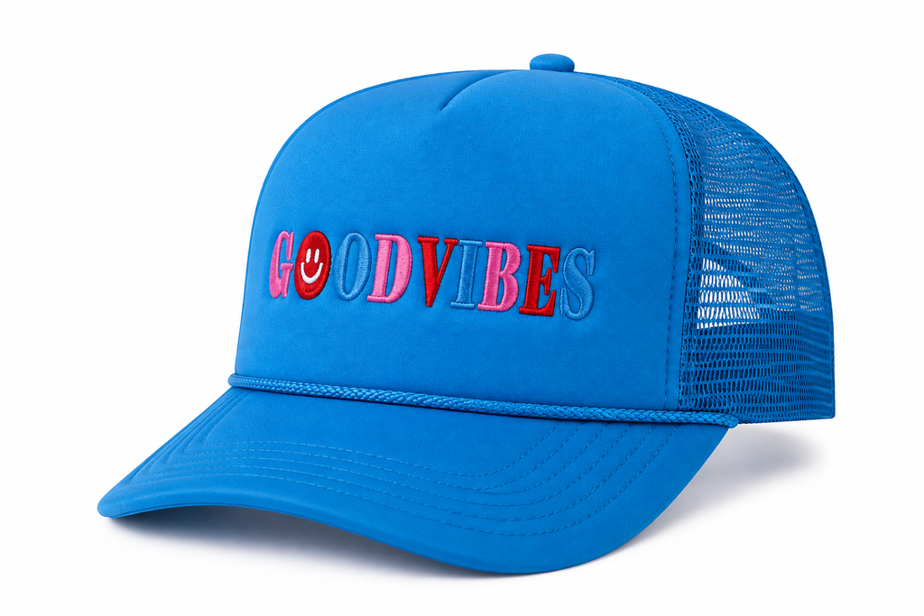 Three-quarter view of Good Vibes Trucker Hat showing sky blue foam front with multicolor embroidered lettering, rope accent, and blue mesh back, on a white background.
