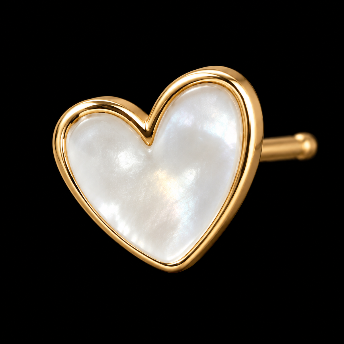 Close-up of single pearl heart stud earring with polished gold-tone bezel setting and gold post backing on black background
