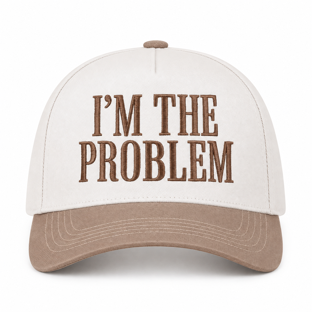 I'm the Problem Baseball Cap in Ash Mocha front view showing cream cotton crown with mocha raised serif block I'm the Problem embroidery, mocha bill, and mocha top button on white background
