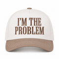 I'm the Problem Baseball Cap in Ash Mocha front view showing cream cotton crown with mocha raised serif block I'm the Problem embroidery, mocha bill, and mocha top button on white background
