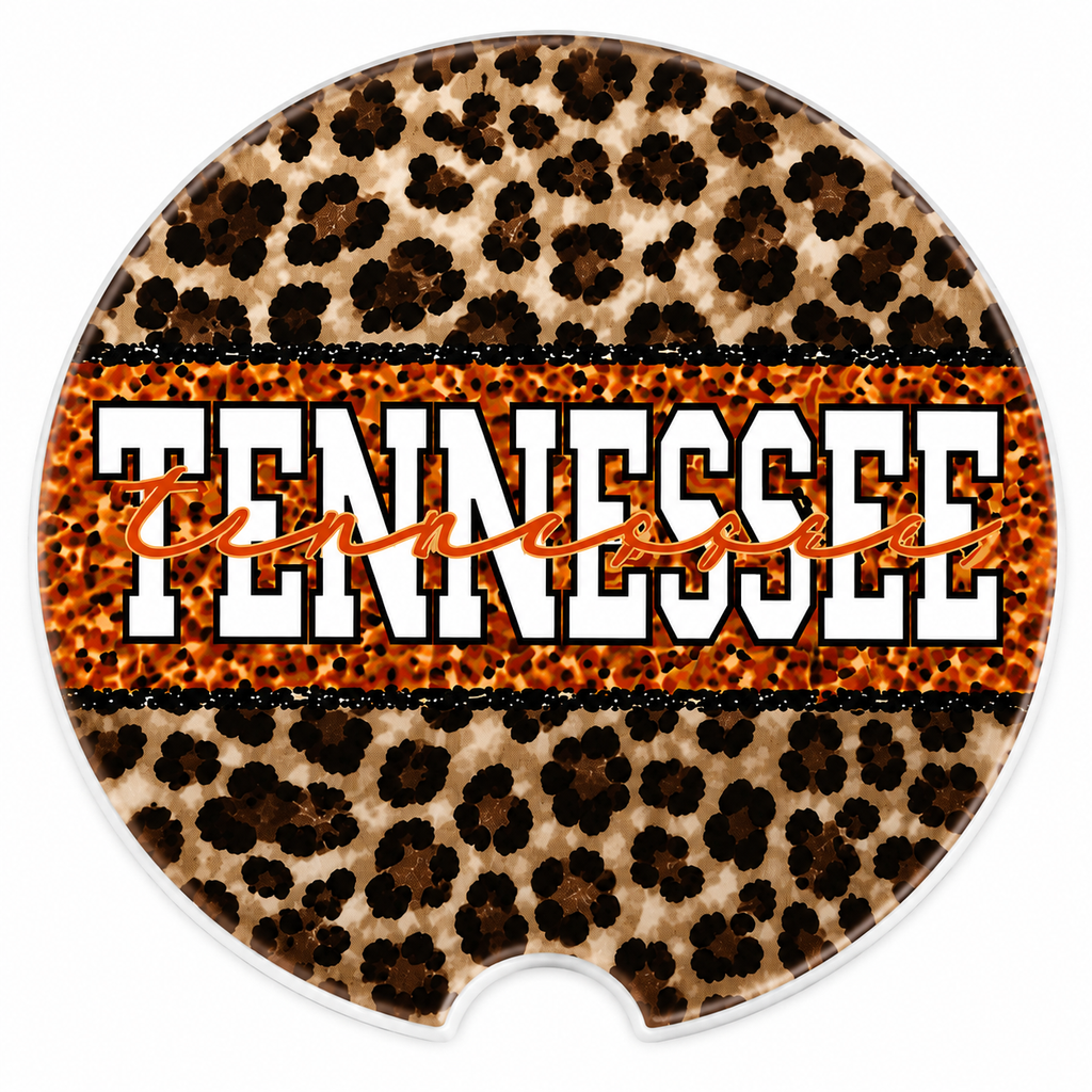 Close-up of Tennessee Leopard ceramic car coaster — leopard print background with bold white and orange "Tennessee" block lettering and orange script overlay, finger notch visible
