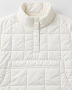 Close-up of the white puffer jacket's stand-up collar and four white dome snaps.
