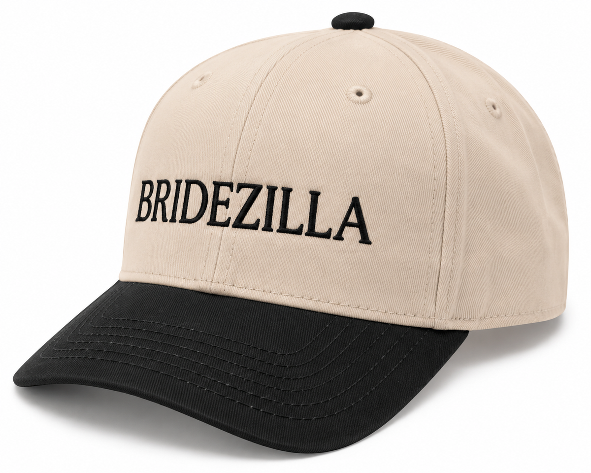 Bridezilla Baseball Cap three-quarter angle view showing cream structured crown, black bill, and bold black embroidered BRIDEZILLA lettering on white background
