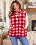 Model wearing the pink, coral, and burgundy plaid sherpa vest over a white long-sleeve top with jeans
