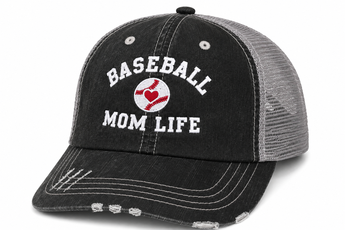Distressed black trucker hat with gray mesh back and white embroidered Baseball Mom Life text with a red heart baseball graphic on the front panel.