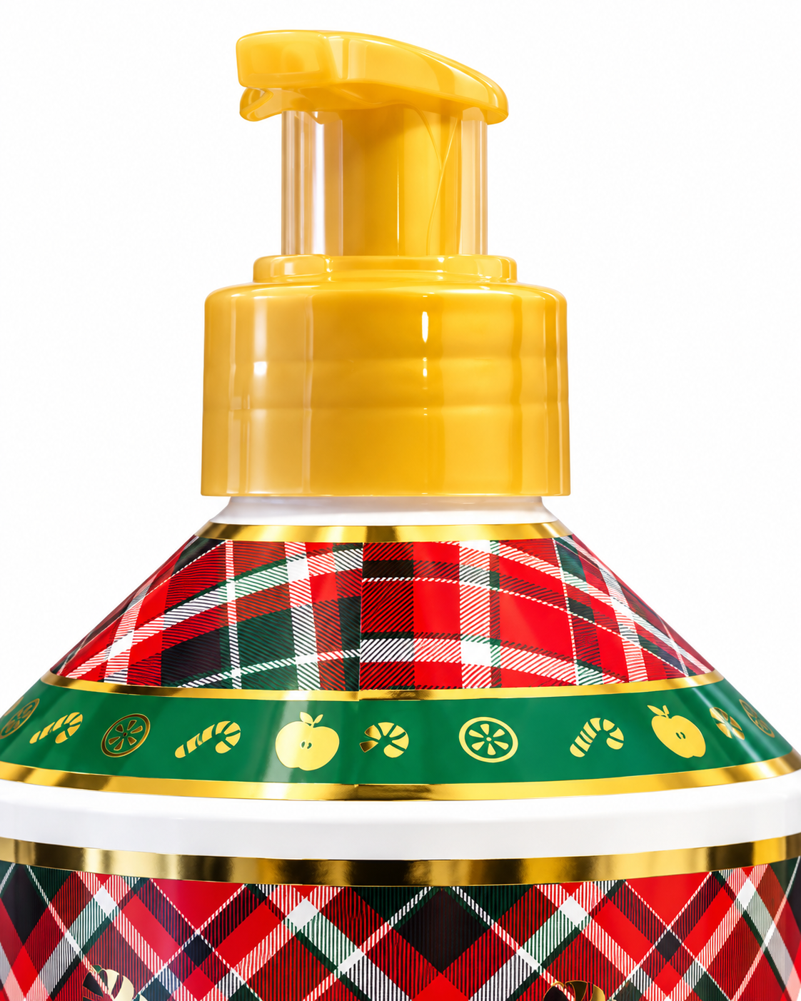 Close-up of the gold-colored hand soap pump and plaid bottle shoulder with decorative apple, candy, and citrus motifs

