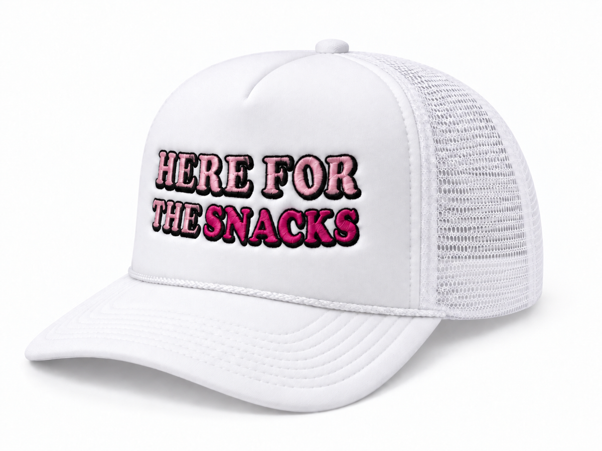 Here for the Snacks Trucker Hat three-quarter angle view showing white structured front, white bill and mesh back, and pink and hot pink embroidered Here for the Snacks lettering with black outline on white background
