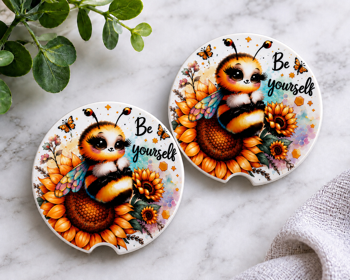 Be Yourself Car Coaster Set — set of 2 ceramic coasters with cute fluffy bumblebee on sunflowers and "Be Yourself" script, butterflies and watercolor accents on white, on marble background
