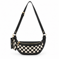 Duo Checkered Crossbody Bag in Black front view showing black and cream checkered vegan leather body with black trim, gold zipper closure, coordinating checkered mini wallet clipped to left side with gold hardware, and adjustable black vegan leather strap with gold buckle on white background
