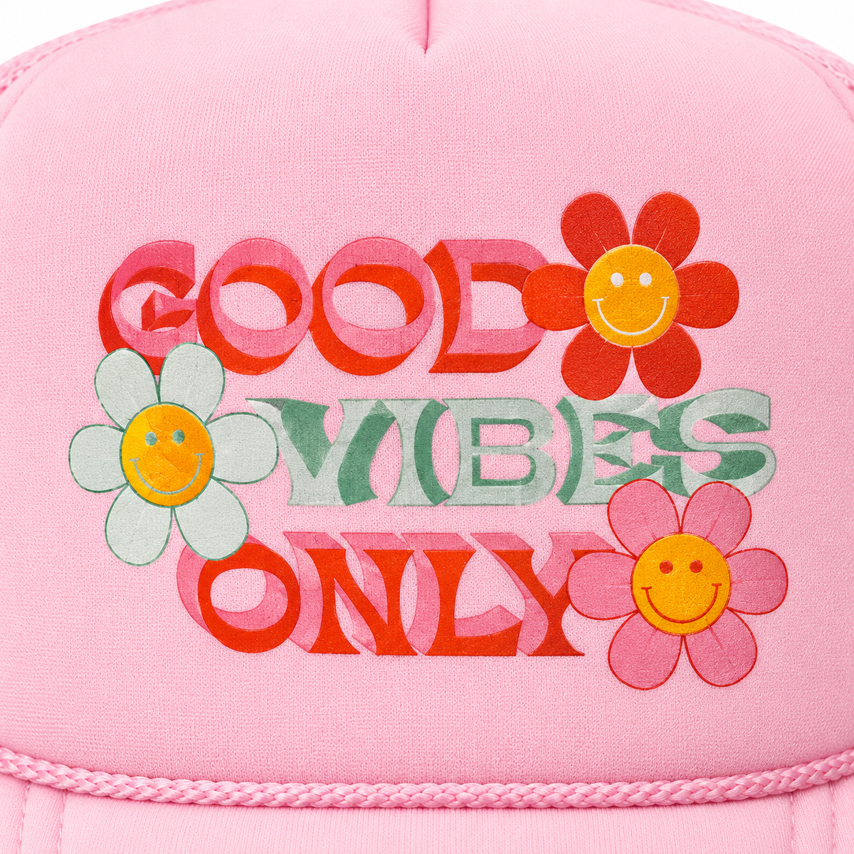 Close-up of retro red and green Good Vibes Only lettering with red white and pink smiley face daisy flowers on pink trucker hat front panel
