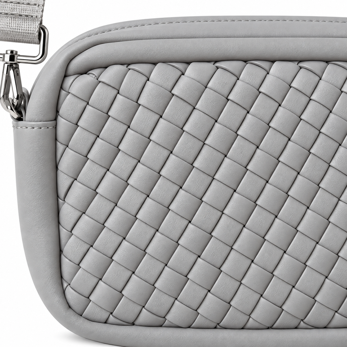 Close-up of Gray Woven Crossbody Bag showing light gray interlaced basketweave panel texture, smooth gray perimeter trim, top zipper closure, and silver swivel clip hardware on adjustable gray strap
