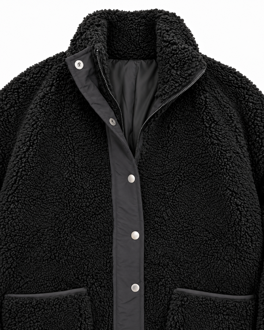 Close-up of the black sherpa jacket showing its stand-up collar, zipper, silver-tone snaps, smooth black placket, and pocket trim
