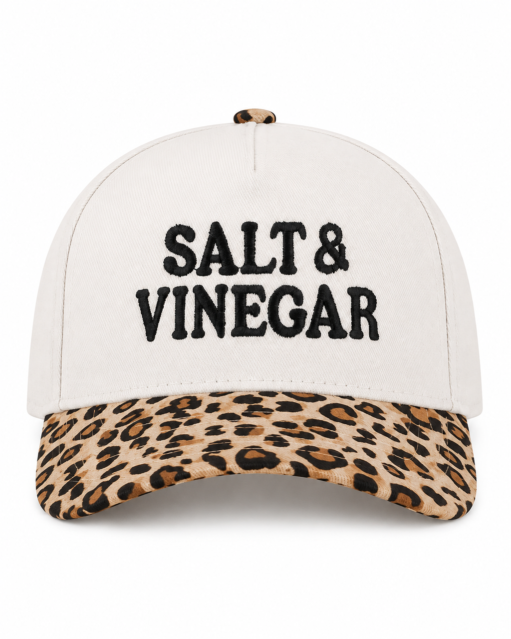 Salt & Vinegar Two-Tone Baseball Cap in Leopard front view showing cream structured cotton crown with bold black embroidered Salt & Vinegar block lettering, tan and brown leopard print bill, and leopard print top button on white background
