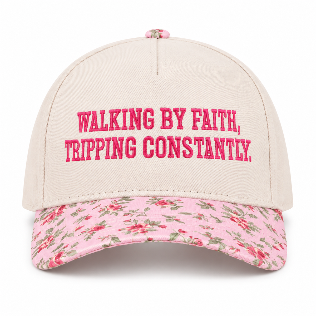 Walking By Faith Tripping Constantly Baseball Cap in Floral front view showing cream cotton crown with hot pink embroidered Walking By Faith Tripping Constantly block lettering, pink floral bill with red roses and green leaves, and pink floral top button on white background
